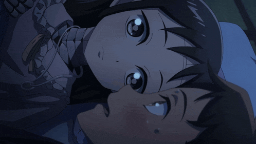 a boy and a girl are laying next to each other and the girl is looking up at the boy
