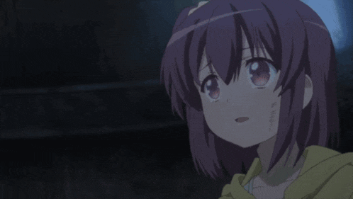 a girl with purple hair and a yellow hoodie is crying