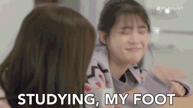 a girl is making a funny face while another girl says studying my foot