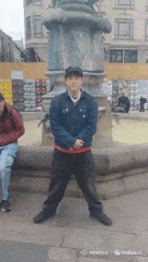 a man standing in front of a fountain with the word hailuo on the bottom