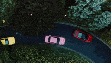 a group of cars are driving down a road