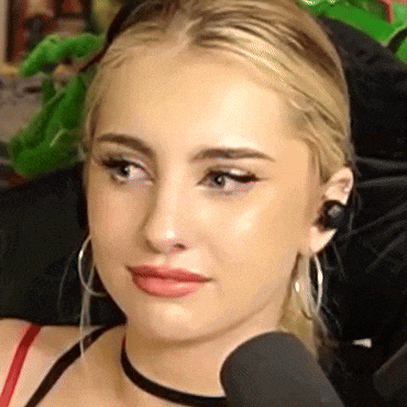 a close up of a woman 's face wearing a choker and earrings