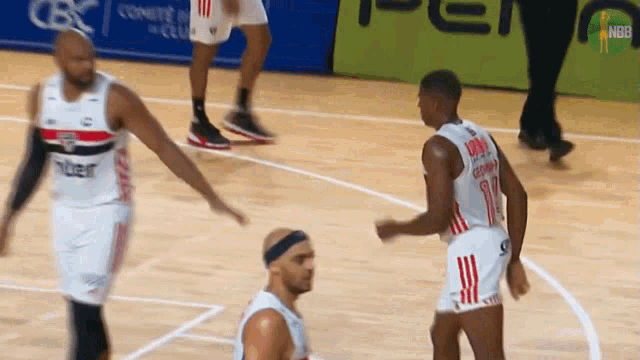 basketball players on a court with one wearing the number 18