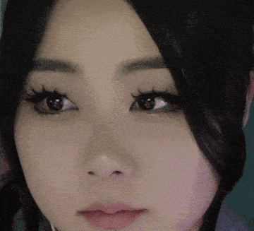 a close up of a woman 's face with a tear running down her cheek