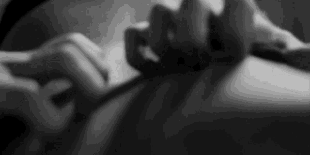 it is a black and white photo of a person holding a sword .