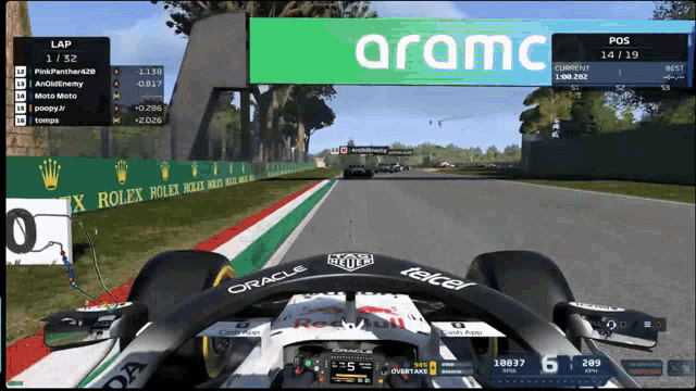 a race car is driving down a track with aramc written on the bottom
