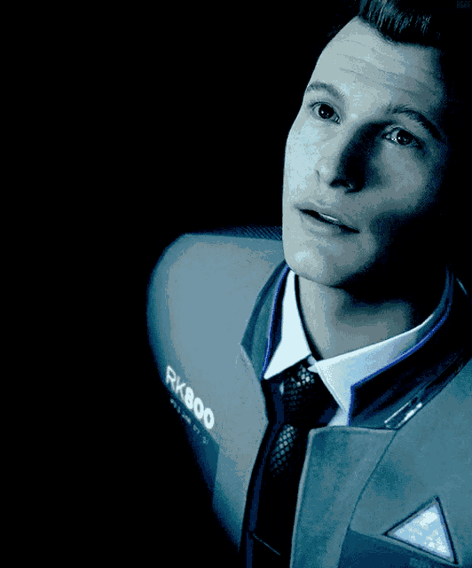 a man in a suit with rk800 on his jacket