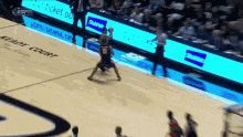 a basketball game is being played on a court with a sign that says ticket do