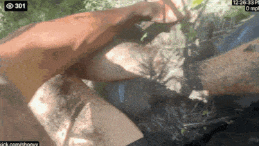 a person 's feet are covered in dirt and the time is 12:26.33 pm
