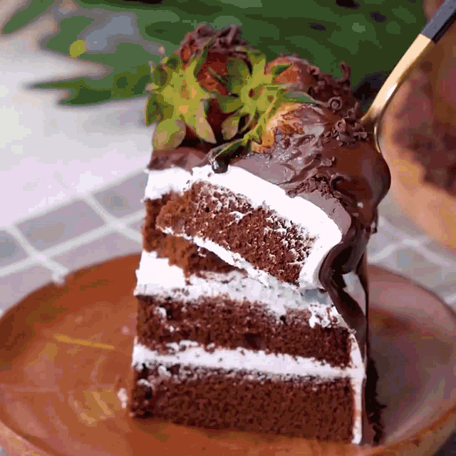 a slice of chocolate cake with whipped cream and strawberries on top