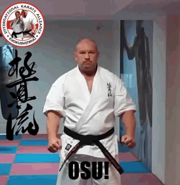 a man in a white karate uniform with a black belt and the word osu on the bottom