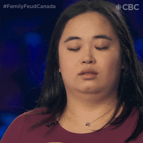 a close up of a woman 's face with her eyes closed and the words family feud canada above her