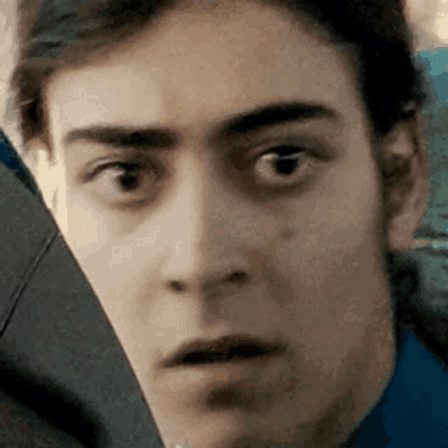 a close up of a man 's face making a funny face .