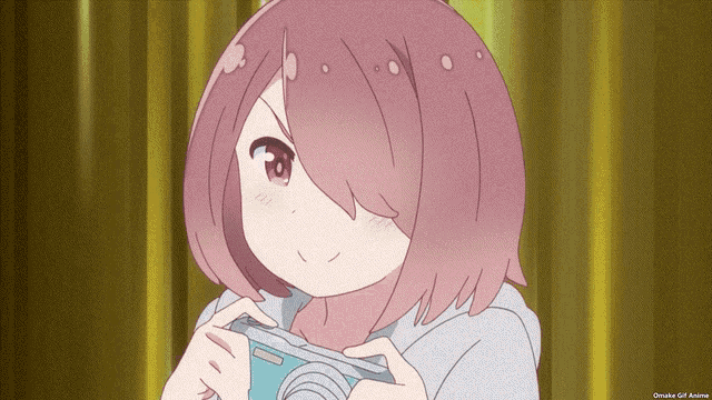 a girl with pink hair is holding a panasonic camera in her hands