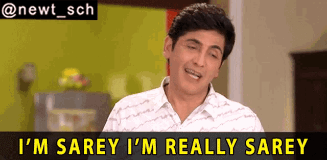 a man says " i 'm sarey i 'm really sarey " in front of a green wall