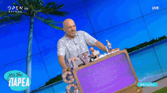 a man stands in front of a sign that says tv on it