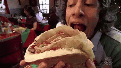 a person is eating a taco in a restaurant .