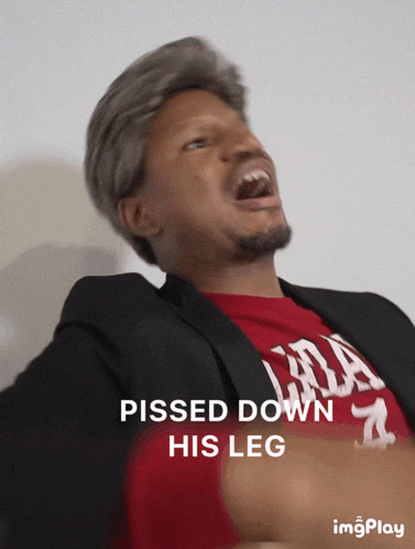 a man in a suit and a red shirt with the words pissed down his leg on the bottom