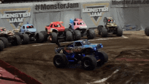 a row of monster jam trucks on a track