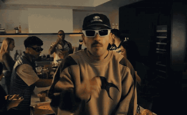a man wearing sunglasses and a hat that says california on it