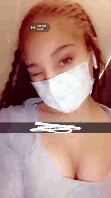 a woman wearing a face mask has a sticker that says she bad on it