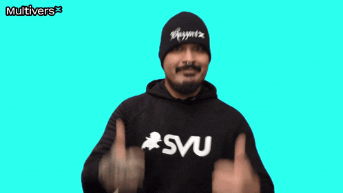 a man giving a thumbs up wearing a svu sweatshirt