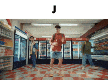 a man in a red shirt is dancing in a store with the letter j below him