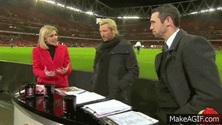 a woman in a red jacket is talking to two men