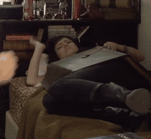 a woman laying on a bed with a book called shock
