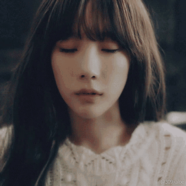 a close up of a woman 's face with the hashtag 309xaoe