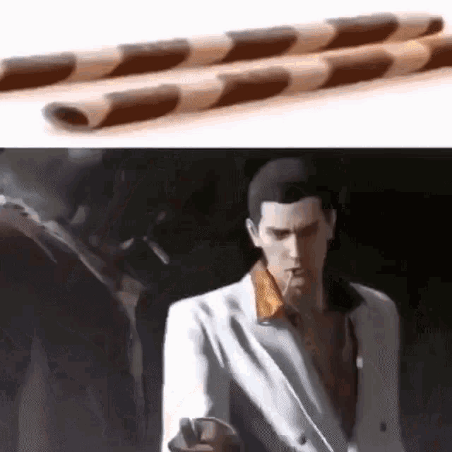 a man is smoking a cigarette next to a stack of chocolate wafer sticks .