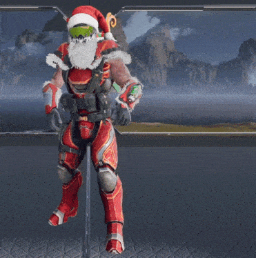 a man in a santa hat is standing in front of a window with mountains in the background
