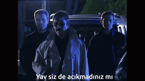 a group of men standing in front of a car with the words yay siz de acikmadiz mi on the bottom