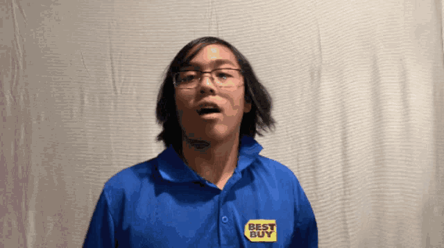 a man wearing a blue shirt that says best buy