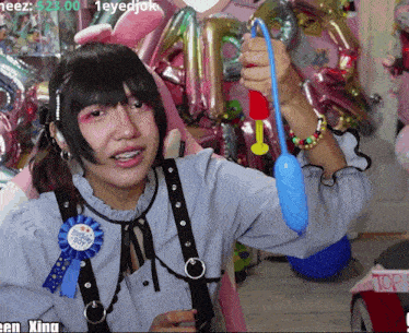 a girl wearing a pin that says ' happy birthday boy ' on it