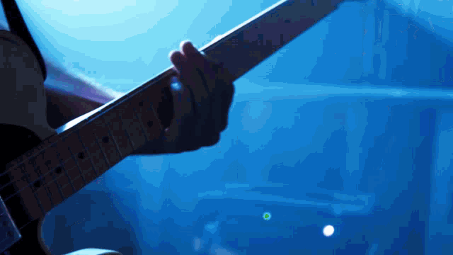 a close up of a person playing an electric guitar