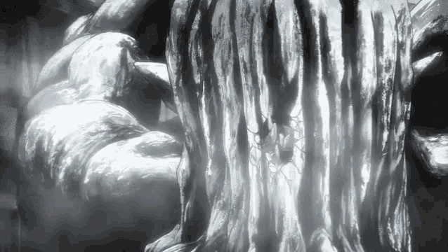 a black and white photo of a statue with a spider crawling out of it