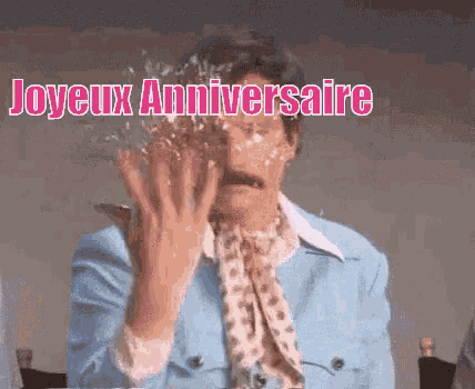 a woman in a blue suit is covered in cake and the words joyeux anniversaire are written above her .