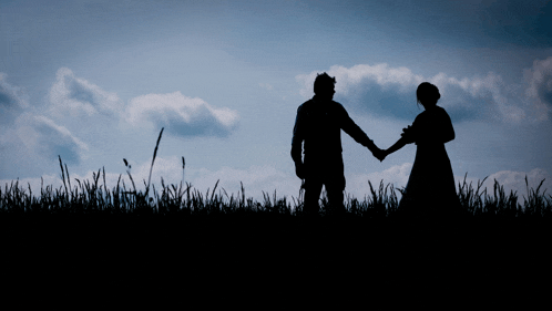 a silhouette of a man and woman holding hands
