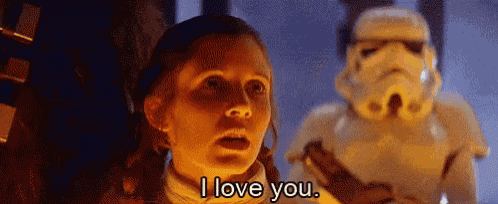 a woman is standing in front of a stormtrooper and saying `` i love you '' .