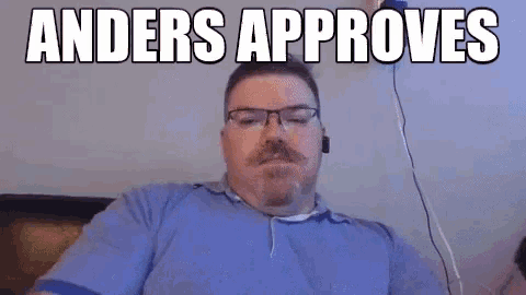 a man with glasses and a mustache is sitting on a couch with the words anders approves above him .