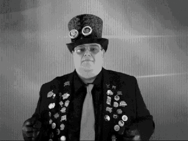 a black and white photo of a man wearing a top hat and tie