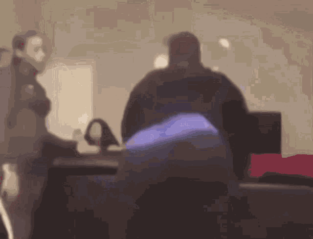 a blurry picture of a man and a woman standing in a room