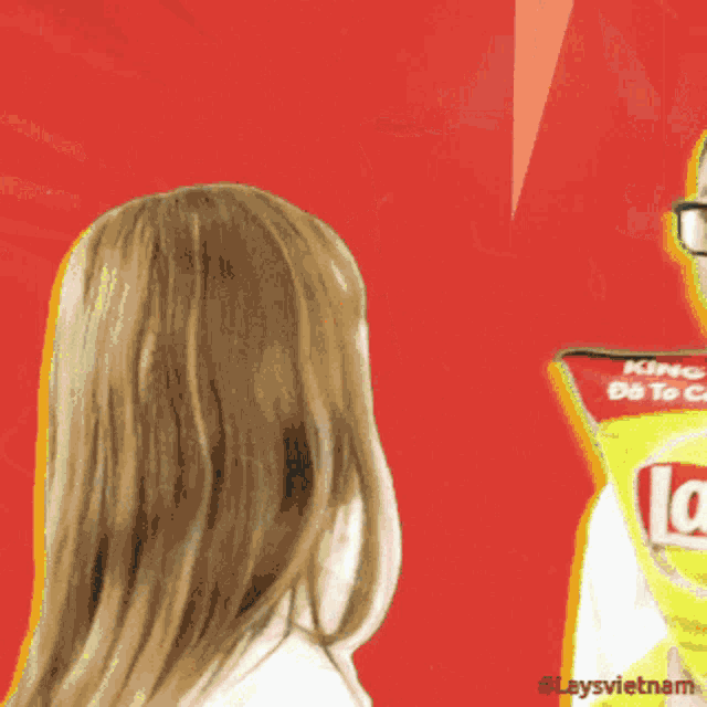 a man covering his face with a bag of lay 's chips