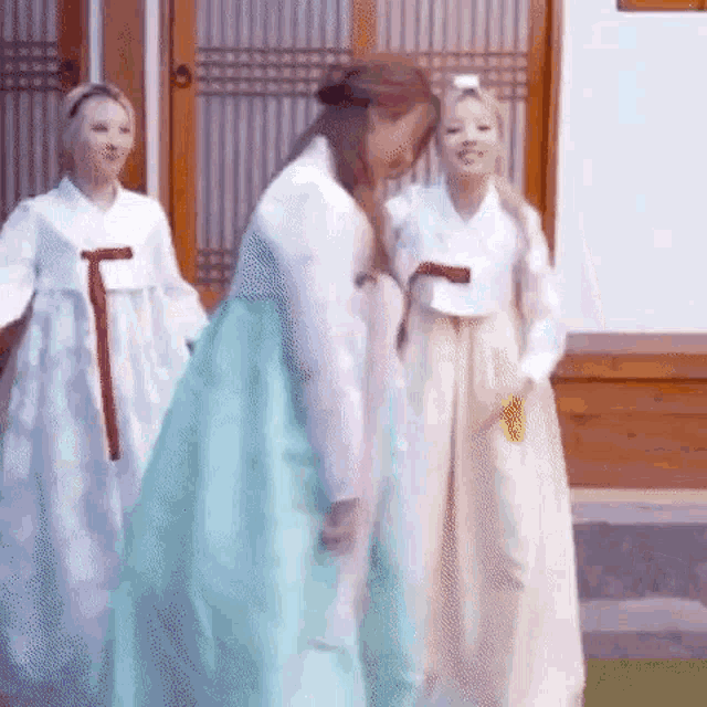 a group of women are standing next to each other in traditional korean clothing .