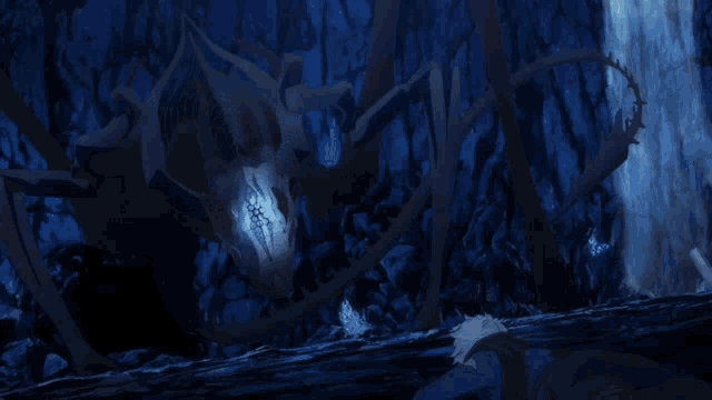 a person laying on the ground in front of a giant monster