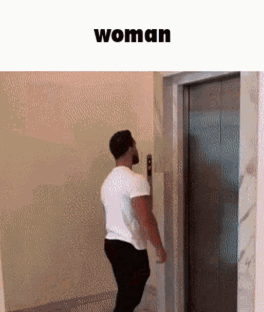 a man in a white shirt is standing in front of an elevator with the word woman below him .