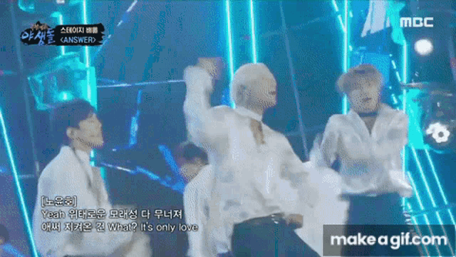 a group of young men are dancing on a stage with a mbc logo in the corner
