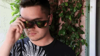 a man wearing sunglasses and a black shirt