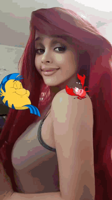 a woman with red hair has a fish on her shoulder